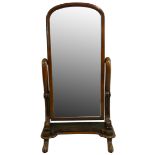 A Victorian mahogany cheval mirror, the arched swivel mirror supported by scroll rams to a shaped