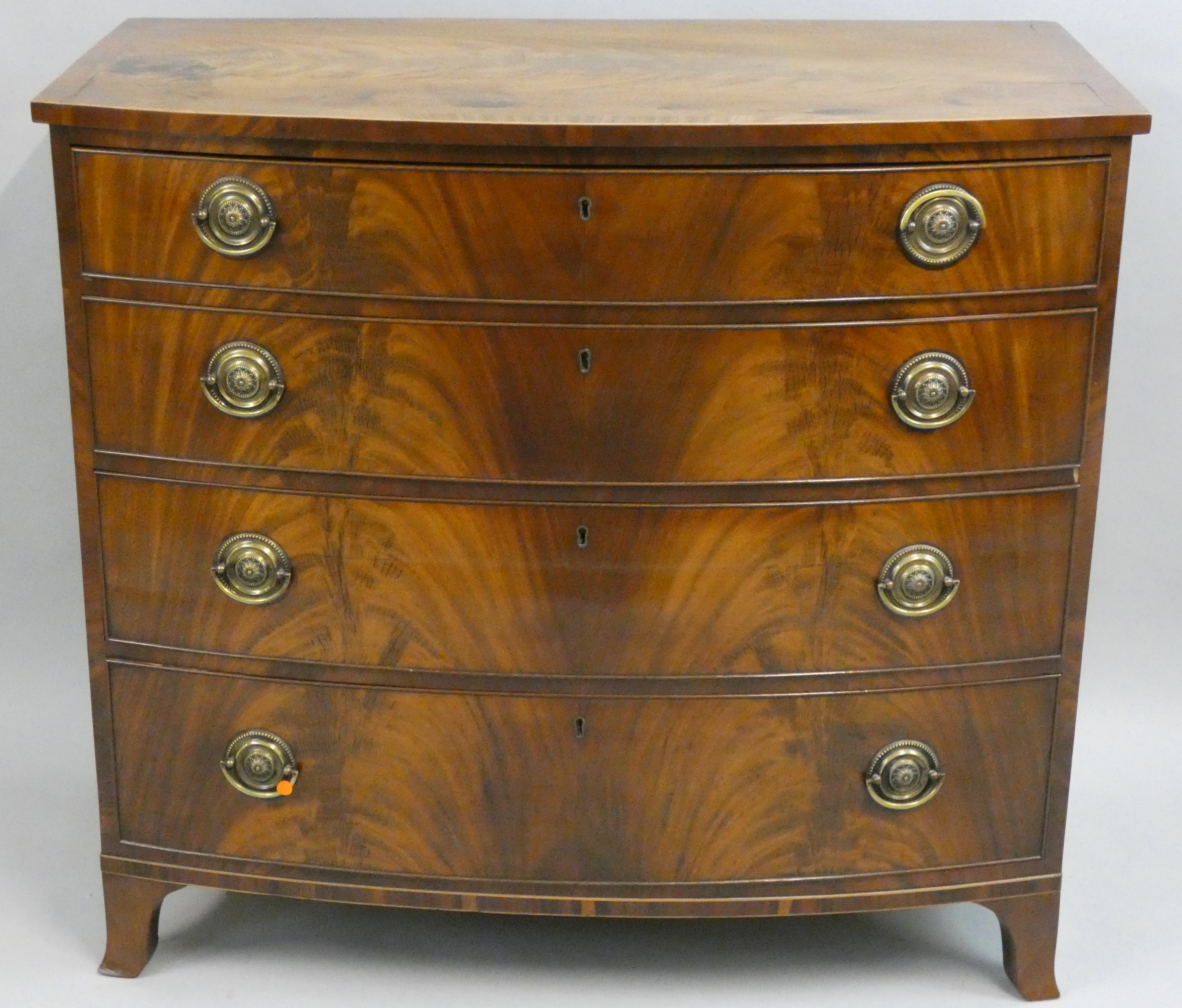 A 19th century mahogany bow front chest of drawers, composed of four graduated drawers, boxwood