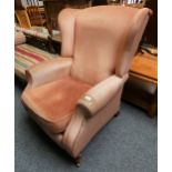 A Parker Knoll recliner armchair in pink fabric