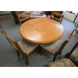 A circular pine dining table 103cm diameter together with a set of four pine dining chairs (5)