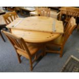 A circular pine extending dining table 152cm wide extended.