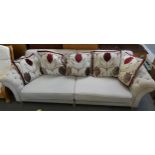 A substantial three seater settee in beige fabric with matching floral scatter cushions approx 275cm