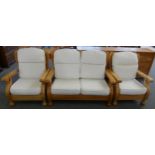 A pine framed three piece suite comprising of a two seater settee and two armchairs in cream