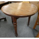 A Victorian pitch pine cricket table with revolving circular top 95cm wide