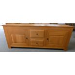 A medium oak sideboard with two central drawers with covers to each side 218cm long by 49cm deep and