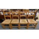 A set of four rush seated ladderback pine dining chairs (4)