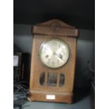 An oak bodied mantle clock with visible mechanism and chime