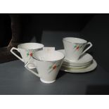 Three art deco design tea cups saucers and cake plate with hand decorated detailing