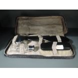 A dress and brush set with ebony handles