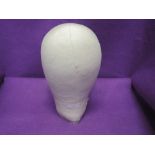 A shop display style manikin head or hat stand