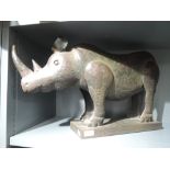 A metal bodied figure of an African Rhino with a rustic finnish