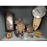 A selection of wall mounted clocks including 31 Day and Black Forrest style cuckoo clock