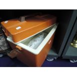 A 70's design picnic cooler box in orange and brown