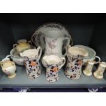 A selection of ceramics including charger water jug and graduated Imari ware pitchers