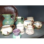 A selection of ceramic jugs including Watcombe Motto ware milk and cream jugs including Ambleside