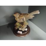 A ceramic figure of a blackbird in a Cappo De Monte style