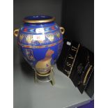 A reproduction Egyptian design vase by the Franklin Mint The Golden Vase of Bast with brass stand