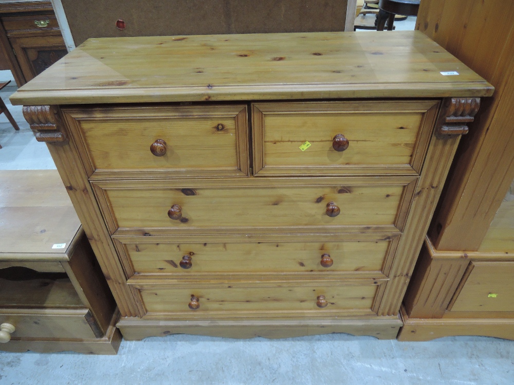 A modern pine chest of two over three drawers in the classical style