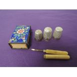 Three HM silver thimbles an enamelled matchbox cover and a bone handled tooth pick