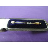 A cased cultured pearl stick pin on a diamond chip set crown mount to yellow metal pin, no marks