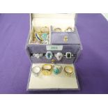A small travel jewellery case containing a large selection of fashion rings, many stamped 925