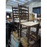 A pair of tradtional ladder back dining chairs