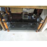 A modern smokey glass TV stand