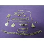 A small selection of white metal jewellery including brooch, ID bracelet, pendant with earrings,