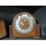 An oak bodied mantle clock with chime and art deco design