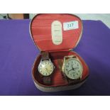 A vintage travel jewellery box containing two wrist watches including Smiths