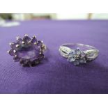 Two ladies dress rings including an amethyst style oval cluster on a raised claw set basket mount on