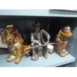 Two Majolica style spaniel dog figures and John Wayne figure seated with rifle