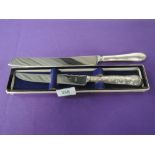A silver handled cake knife having moulded decoration, Sheffield 1975, Harrison Brothers, and