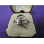 A white metal dress ring of stylised form, stamped 925, size Q