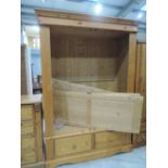 A modern pine wardrobe with double drawer under