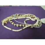 Five pieces of simulated pearl and stone jewellery including four necklaces and a bracelet