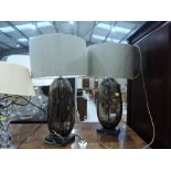 A pair of modern table lamps having smoked glass bases