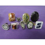 Nine white metal fashion rings including enamelled and shell