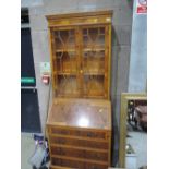 A reproduction yew wood bureau bookcase