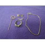 A small selection of 9ct gold and yellow metal including four leaf clover pin, odd earrings,