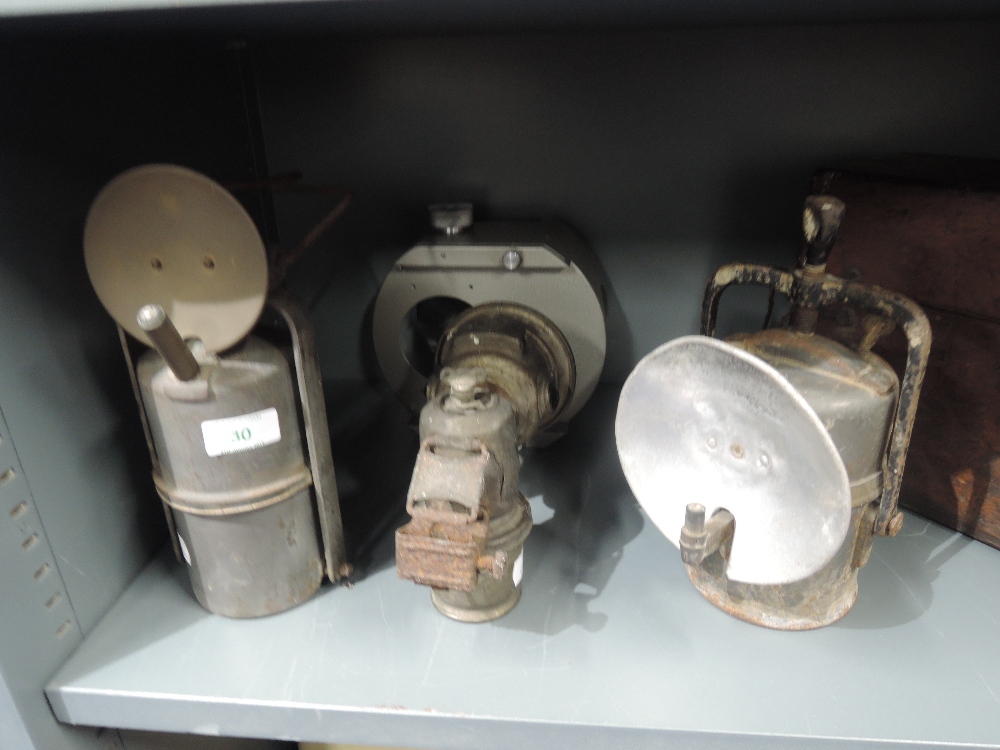 A selection of vintage motor car and cycle lights and lamps including Carbide and Lucas