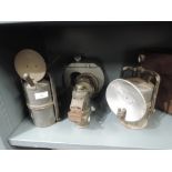 A selection of vintage motor car and cycle lights and lamps including Carbide and Lucas