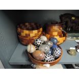 A selection of semi precious stone eggs and turned wooden bowls and biscuit barrel