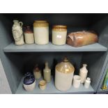 A selection of earthen ware salt glazed kitchen wares including flagon and jars