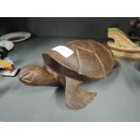A hand carved hard wood sea turtle