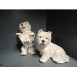 A pair of plaster cast figures of two Scottish terriers