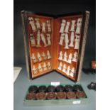 An ornate travelling chess set with Indian inlay design board and Egyptian style pieces