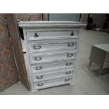 A shabby chic chest of drawers having tiled top