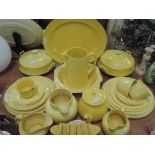 A selection of kitchen wares and table ceramics with yellow glaze