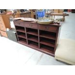 A hardwood shelf unit with frieze drawers